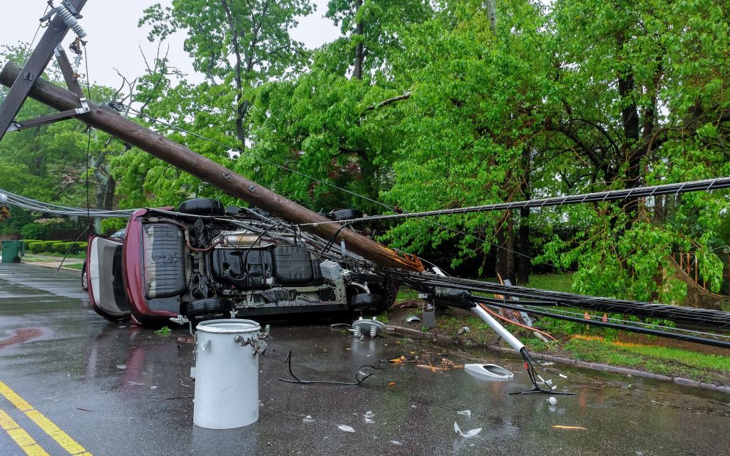 Electricity poles fall because of storms damaged car